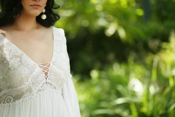 curvy bride wearing a plus size boho wedding dress with lace and a flowing A-line skirt from Studio Levana.