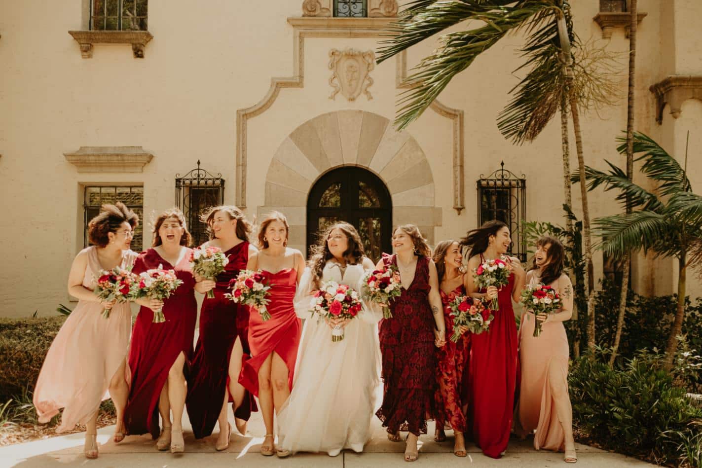 plus-size wedding gown with sheer off-the-shoulder sleeves and a flowing tulle skirt, perfect for a timeless and elegant outdoor ceremony.